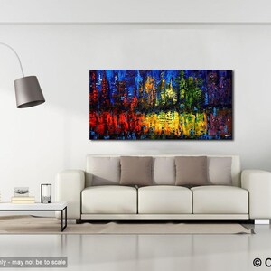 May include: Abstract painting of a city skyline with a reflection in water. The painting is done in a variety of colors, including blue, green, yellow, red, and purple. The painting is displayed on a white wall in a living room setting.