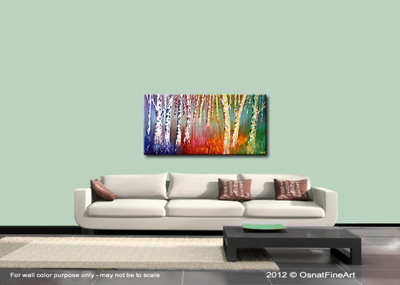 May include: Abstract painting of a forest with colorful trees. The trees are painted in shades of blue, green, yellow, orange, and red. The painting is on a canvas and is framed. The painting is hanging on a wall in a living room.