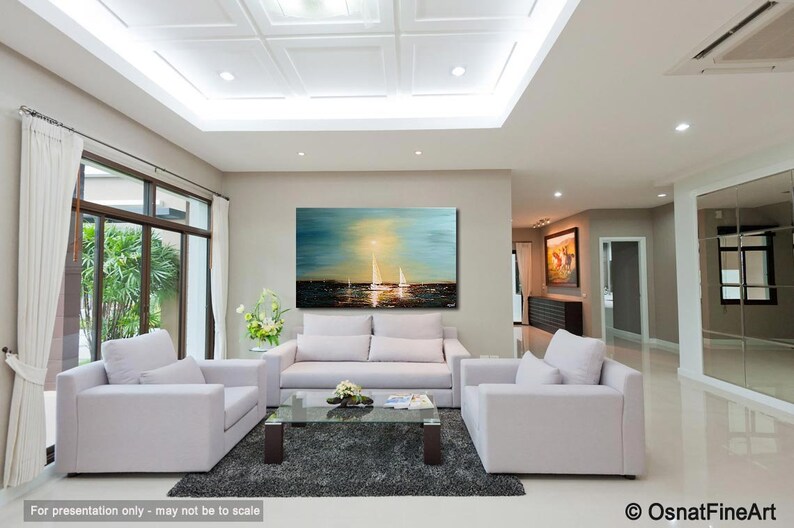 May include: A living room interior with a large abstract painting of a seascape with sailboats. The painting is in shades of blue, green, and yellow. The room is decorated with white furniture and a glass coffee table.