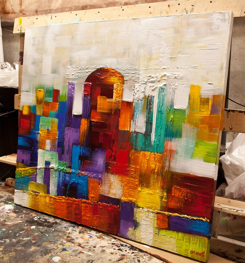 May include: Abstract painting with a textured surface. The painting features a variety of colors, including red, orange, yellow, green, blue, and purple. The colors are arranged in a geometric pattern, creating a sense of movement and energy.