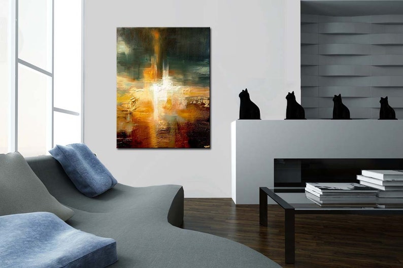 May include: Abstract painting with a mix of warm and cool colours, featuring a central white shape surrounded by shades of orange, yellow, brown, and green. The painting is displayed on a white wall in a modern living room setting.