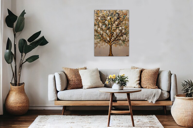 May include: A painting of a gold and green tree with a textured surface. The painting is hanging on a wall in a living room setting with a couch, coffee table, and plants.