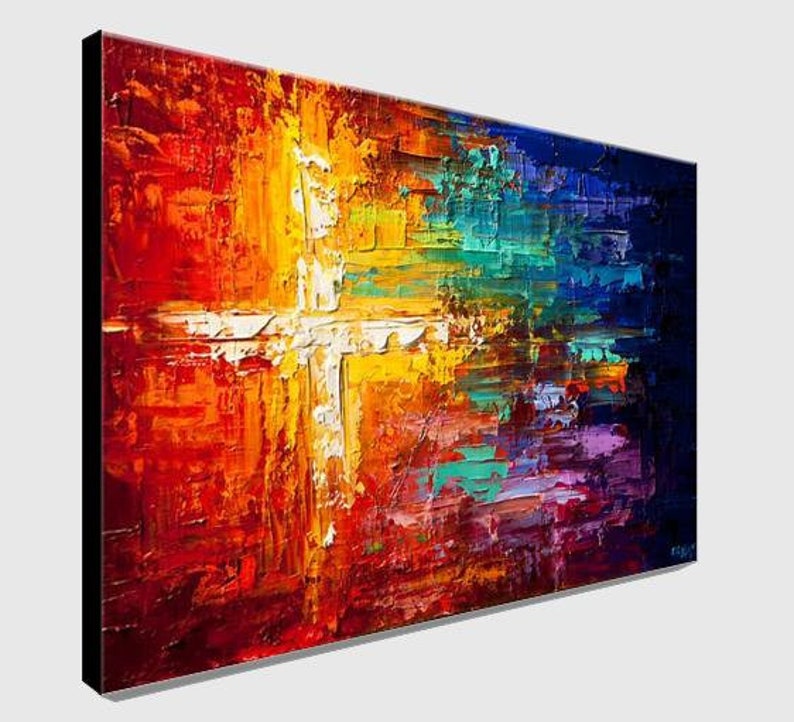 May include: Abstract painting of a white cross on a colorful background. The background is a mix of red, orange, yellow, green, blue, and purple. The cross is painted in a thick, textured style.