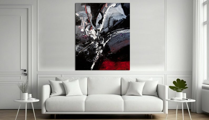 May include: Abstract painting with black, white, and red paint splatters and streaks. The painting has a modern and contemporary style.
