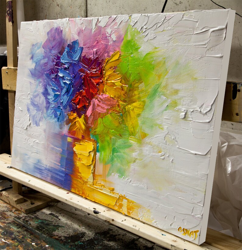 May include: Abstract painting of a colorful bouquet of flowers in a yellow vase. The flowers are painted in shades of purple, pink, red, yellow, and green. The background is white with a textured surface.