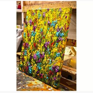 May include: A colorful abstract painting of a field of flowers in shades of yellow, green, blue, purple, and red. The paint is applied in thick, textured strokes, giving the painting a three-dimensional effect.