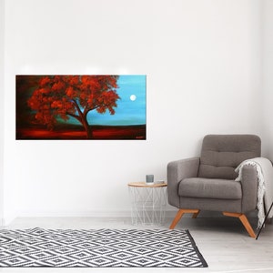 May include: A painting of a red tree with a full canopy against a blue sky with a white moon. The tree is in the foreground and the sky is in the background.