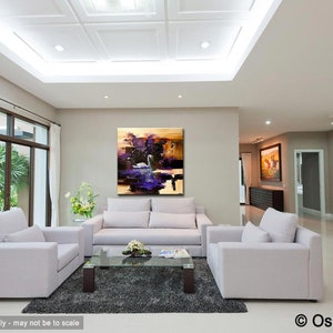 May include: Abstract painting of a white swan on a purple lake with a gold and brown background. The painting is hanging on a wall in a living room with white couches and a coffee table.