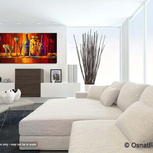 May include: Abstract painting of a still life with colorful bottles and glasses on a red background. The painting is framed and hanging on a white wall in a living room setting.
