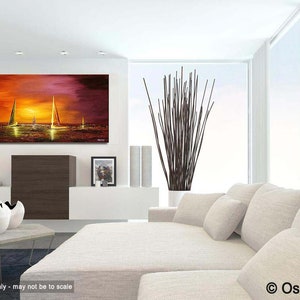 May include: A painting of a sunset over the ocean with sailboats in the distance. The painting is in a modern living room setting with a white couch and a vase of branches.
