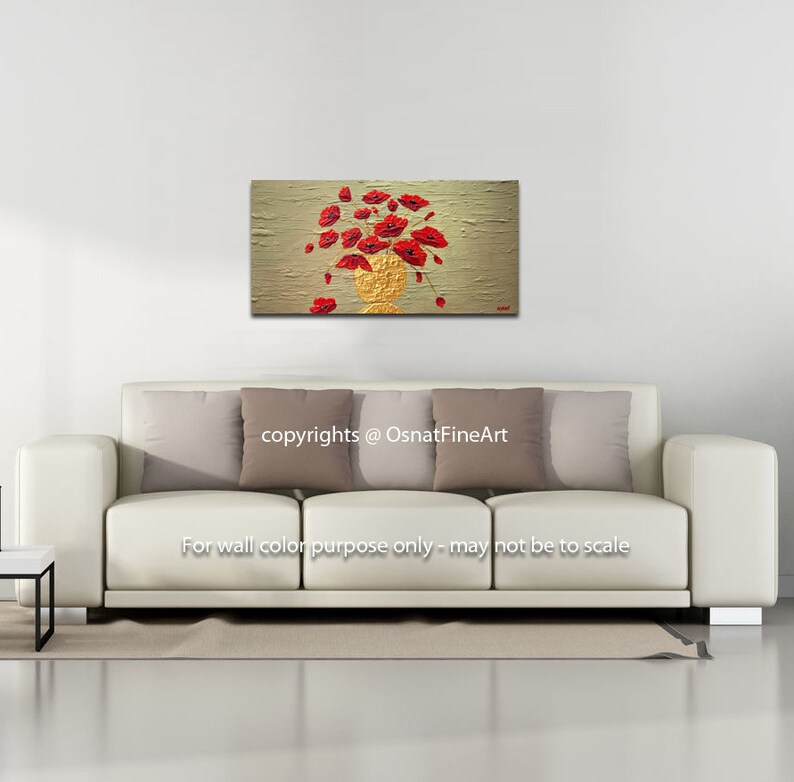 May include: A painting of a bouquet of red poppies in a gold vase on a textured beige background. The painting is displayed on a white wall above a white sofa with beige pillows.