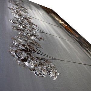 May include: Abstract painting on canvas featuring a silver and brown textured design. The painting depicts a series of stylized trees with branches extending to the right. The background is a light gray color.