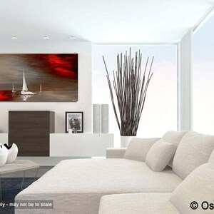 May include: Abstract painting of sailboats on a red and gray water scene. The painting is hanging on a white wall in a modern living room with a white couch and a vase of brown branches.
