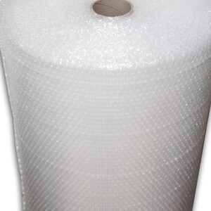 May include: A roll of white bubble wrap, a protective packaging material used for shipping and storage.