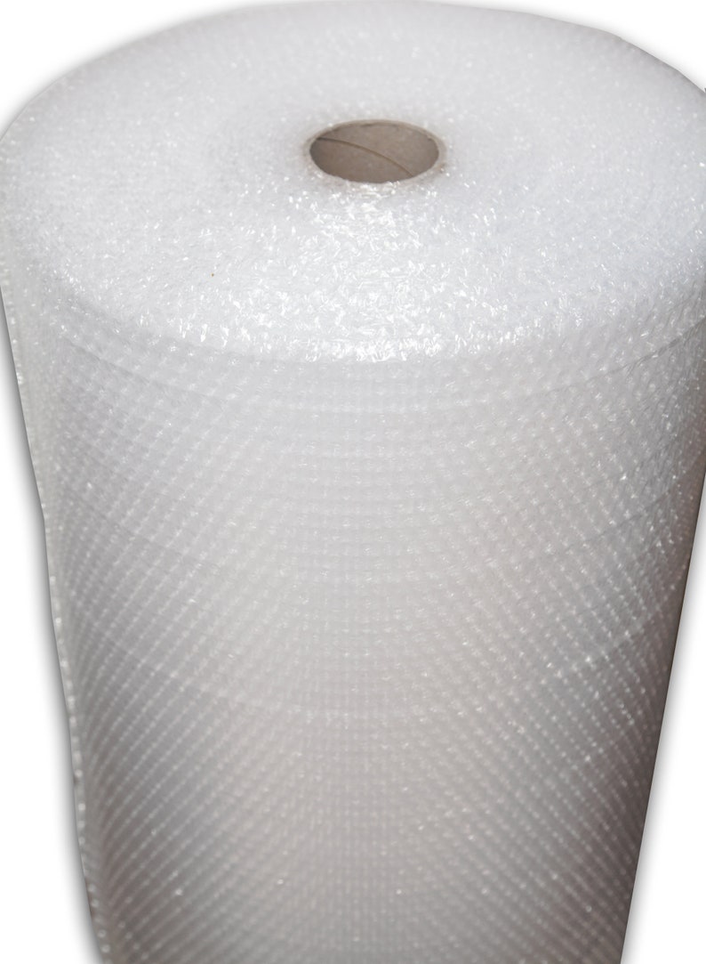 May include: A roll of white bubble wrap, a protective packaging material used for shipping and storage.