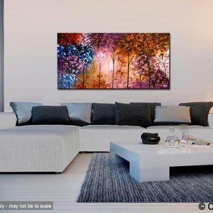 May include: Abstract painting of a forest scene with colorful trees in shades of purple, orange, red, and blue. The painting is displayed on a white wall above a white sectional sofa with gray throw pillows.