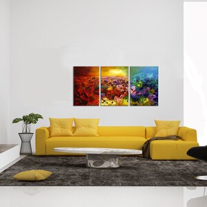 May include: A three-piece abstract art print set featuring a field of colorful flowers. The prints are framed and hung on a white wall above a yellow sofa.