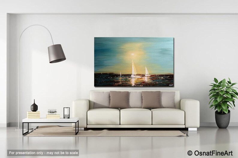 May include: A painting of a seascape with sailboats in the distance. The sky is a light blue with a yellow sun shining through the clouds. The water is a dark blue with a reflection of the sun. The painting is framed and hanging on a white wall in a living room setting.