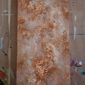 May include: Abstract painting on canvas with a textured surface. The painting features a mix of white and brown paint with gold leaf accents.