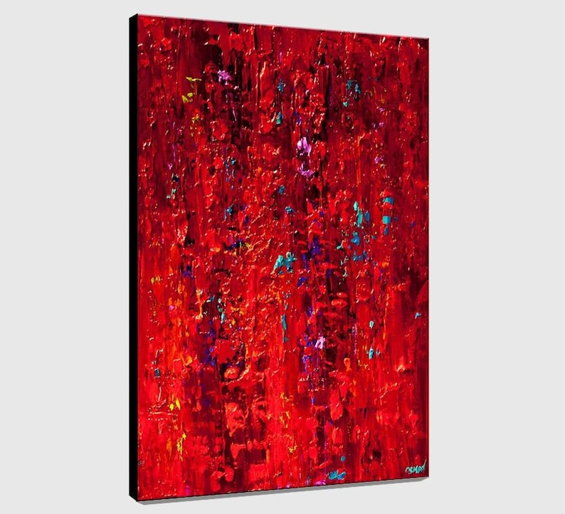 May include: Abstract painting with a red background and splashes of blue, purple, and yellow paint.