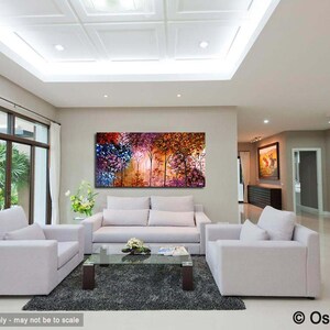 May include: A living room interior design with a large abstract painting of a colorful forest scene hanging on the wall above a white sofa. Two white armchairs are positioned on either side of the sofa, and a glass coffee table sits in front of the sofa. The room has a white ceiling with recessed lighting and a large window with white curtains.