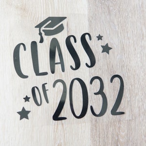 May include: Black vinyl decal with the text "Class of 2032" and a graduation cap. Two small stars are on either side of the text.