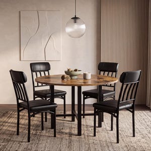May include: A round dining table with a wood-grain finish and a black metal frame, accompanied by four chairs featuring black upholstered seats and backrests with vertical metal slats, arranged around the table in a dining room setting.