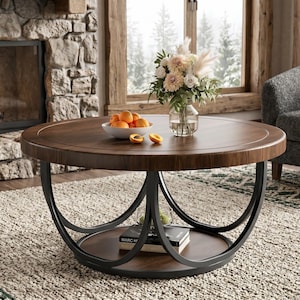 May include: A round coffee table with a dark brown wood grain top and a lower shelf. The table features a black metal frame with curved, intersecting legs. A white bowl filled with orange apricots sits on the top surface next to a glass vase.