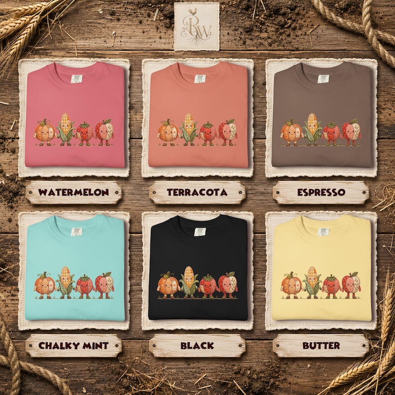 K&ouml;nnte beinhalten: Sechs Rundhals-Sweatshirts in den Farben Wassermelone, Terrakotta, Espresso, Kreideminze, Schwarz und Butter. Jedes Shirt zeigt eine Grafik von vier handhaltenden Cartoon-Gem&uuml;sesorten, darunter ein K&uuml;rbis, ein Maiskolben, eine Erdbeere und ein Apfel.