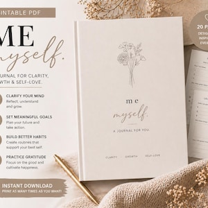 Könnte beinhalten: Ein beiges Notizbuch mit den Worten "ME myself" und "A JOURNAL FOR YOU" auf dem Einband. Das Notizbuch enthält Anregungen für Klarheit, Wachstum und Selbstliebe. Ein goldener Stift liegt auf einer weichen, beigen Oberfläche.