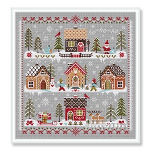 May include: Cross-stitch design featuring a winter village scene with houses, trees, and snow. The design includes a red bird, a snowman, and a Santa Claus figure. The text "ho-ho-ho" is visible in the design.