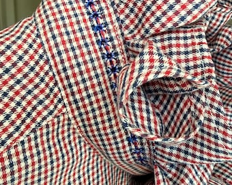 Upcycled from a classic Nautica button-down shirt into a romantic statement blouse featuring an embroidered ruffle collar