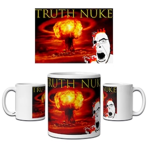 May include: A white ceramic mug featuring a graphic print of a large orange and yellow nuclear explosion against a dark red background. The text TRUTH NUKE is printed in yellow at the top. A stylised illustration of a person with glasses is visible.