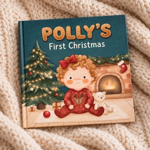 May include: A square hardcover book titled Polly's First Christmas with a dark teal cover. The illustration features a child with curly hair in red pajamas sitting by a lit Christmas tree, a fireplace, and a small white teddy bear toy.
