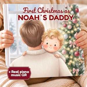 May include: A hardcover book titled First Christmas as NOAH'S DADDY featuring an illustration of a person holding a small child in front of a decorated Christmas tree. A red badge in the corner includes the text + Real piano music QR.
