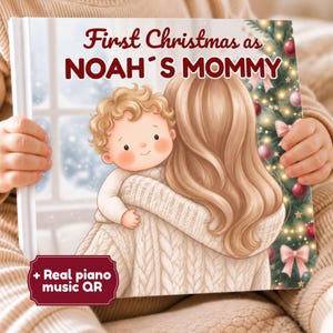 May include: A hardcover book titled First Christmas as NOAH'S MOMMY featuring an illustration of a person with long blonde hair holding a toddler. The cover includes a decorated Christmas tree with pink bows and a badge stating + Real piano music QR.