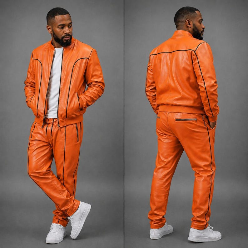 May include: Orange leather tracksuit with black trim. The jacket has a bomber style with a zipper closure and pockets. The pants have a drawstring waist and zippered pockets. The outfit is paired with white sneakers.