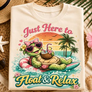 May include: A cream-colored t-shirt featuring a graphic of a green turtle wearing a pink bow and heart-shaped sunglasses, floating on a surfboard with a coconut drink. The text reads "Just Here to Float & Relax" in a colorful, retro-style font.