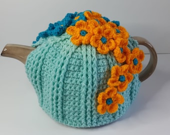 Overflowing flowers tea cosy, exotic flowers flowing over the teapot