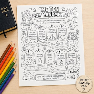 May include: A black and white printable coloring page titled The Ten Commandments featuring a winding path with ten numbered stone tablets, a cartoon figure, and text. A black Bible and colored pencils are positioned next to the paper sheet.