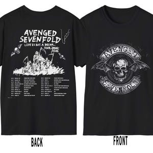 May include: Two black t-shirts with designs related to the band Avenged Sevenfold. One has a skull with wings and the band's name. The other features the text "Life is but a dream... Tour 2025-2026" and a list of tour dates.
