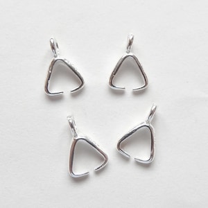 May include: Four silver triangle shaped pendant bails. These are used to attach a pendant to a chain or cord.