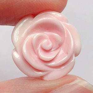 May include: A pink resin rose flower embellishment. The rose has a detailed, realistic design.