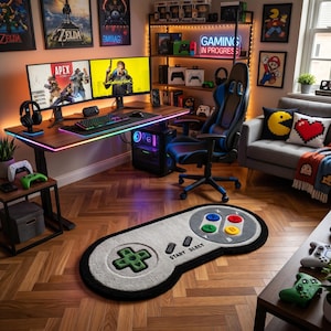 May include: A gaming room featuring a desk with multiple monitors, a gaming chair, and a controller-shaped rug. The room is decorated with video game-themed artwork and accessories, including a neon sign that says "Gaming in Progress". The rug is approximately 100cm in length.