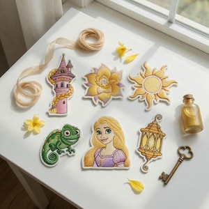 May include: A collection of six embroidered patches featuring a pink tower with long blonde hair, a yellow flower, a golden sun, a green chameleon, a blonde character with long hair, and a gold lantern, alongside a ribbon, key, and bottle.
