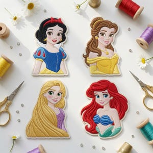 May include: Four embroidered fabric patches featuring cartoon characters: Snow White with black hair, Belle with brown hair, Rapunzel with long blonde hair, and Ariel with red hair. The patches are surrounded by sewing supplies including spools of thread, scissors, and small white flowers.