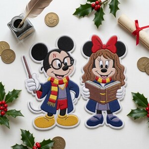 May include: Two embroidered fabric patches featuring cartoon mice dressed as wizards. One mouse wears round glasses, a red and yellow scarf, and a dark blue robe while holding a wand. The other mouse has long brown hair, a red bow, and a book.