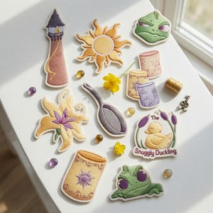 May include: A collection of embroidered patches featuring a tall tower, a golden sun, green chameleons, a frying pan, a yellow flower, lanterns, and a duckling with the text The Snuggly Duckling, accompanied by small beads, a key, and thread.