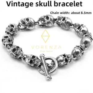 May include: A vintage skull bracelet with a series of detailed skull charms. The bracelet is silver-toned and features a toggle clasp. The chain width is about 0.33 inches. The text "Vintage skull bracelet" is at the top.