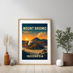 May include: A framed art print featuring a vibrant illustration of Mount Bromo in Indonesia. The artwork showcases a sunset with an orange and blue sky, and the text "MOUNT BROMO INDONESIA" in gold lettering.
